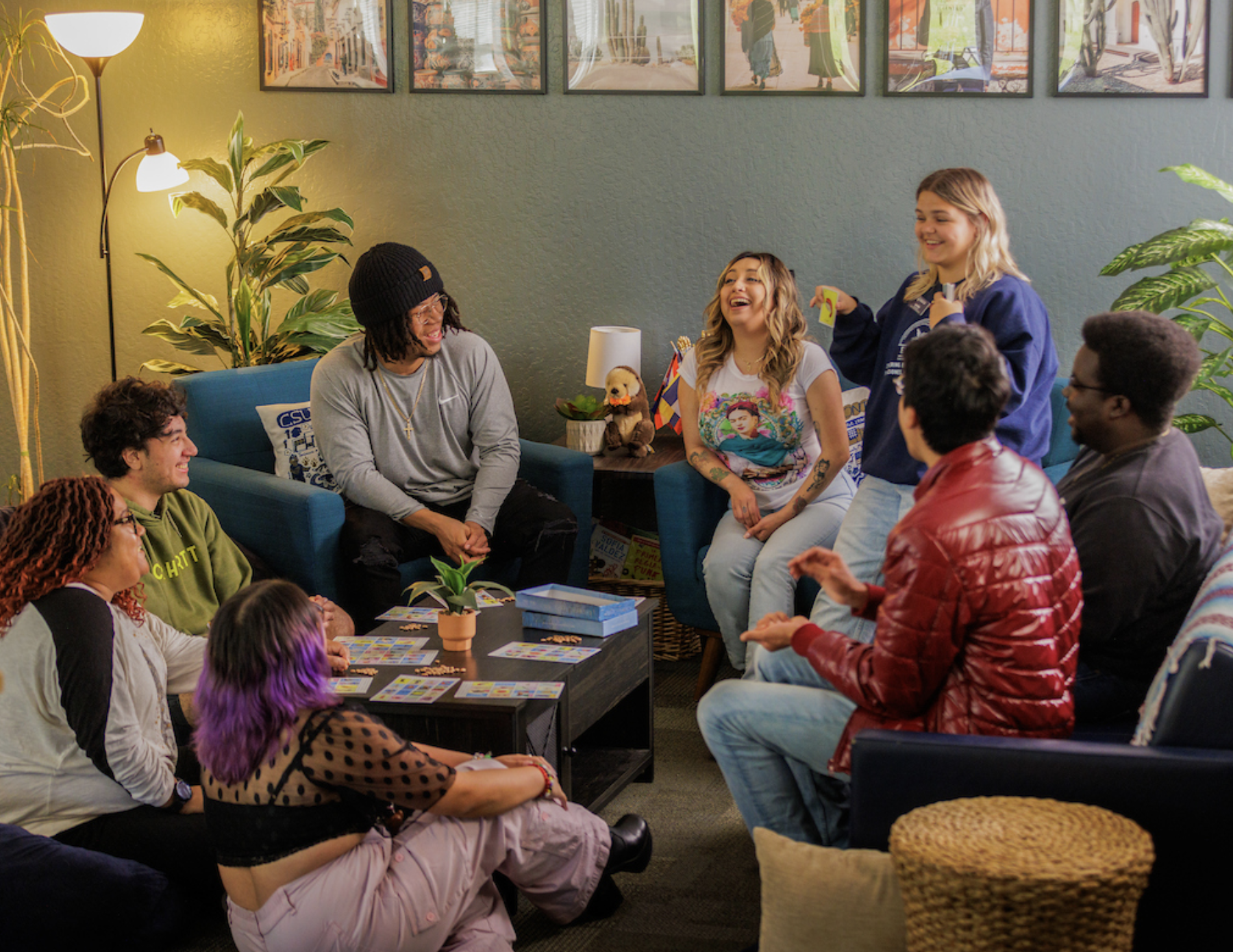 Students sitting around one another smiling